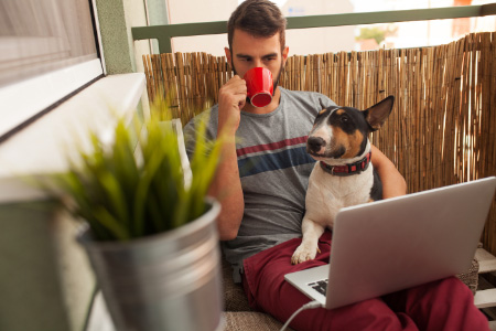 man drinking coffee dog